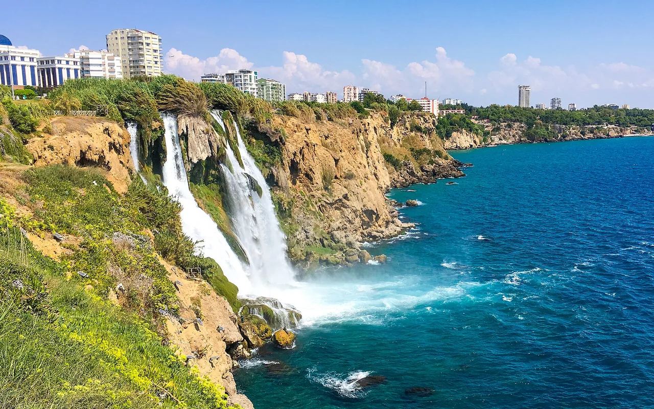 Lower Düden Waterfall cascading from the cliffs into the turquoise Mediterranean
